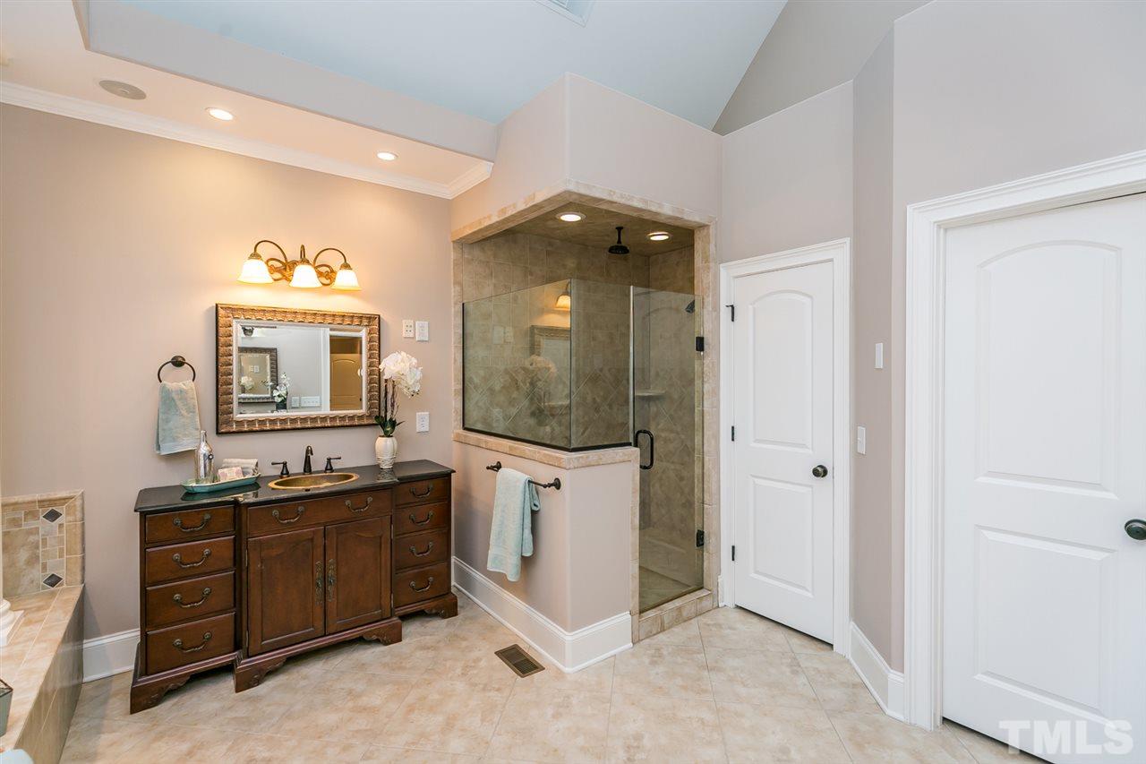 12225 Beestone Lane Raleigh, NC 27614 - Photo 10 of 25 a bathroom with a sink vanity and mirror