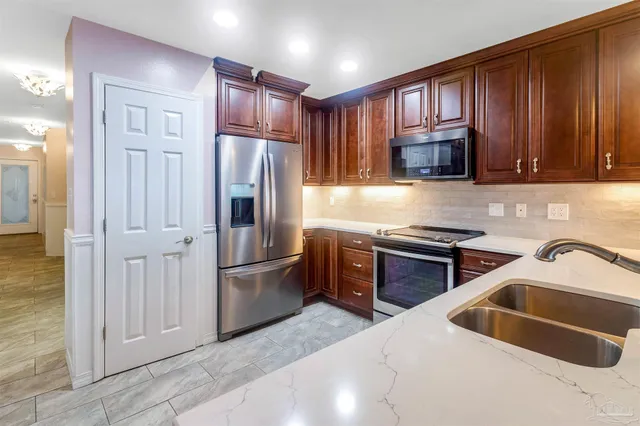 a kitchen with granite countertop stainless steel appliances and cabinets