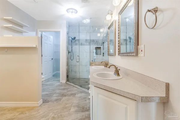 a bathroom with double vanity sinks and a mirror
