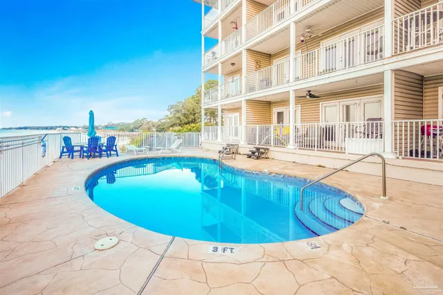 a view of a swimming pool with outdoor seating