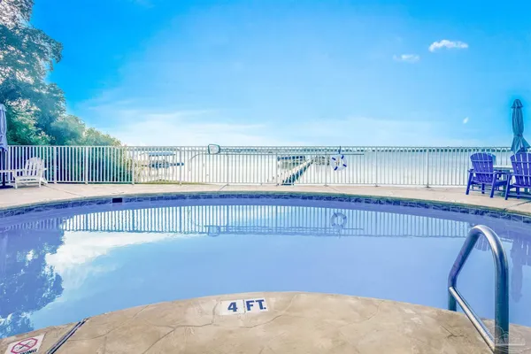 a view of kitchen with stainless steel appliances wooden floor and seating space
