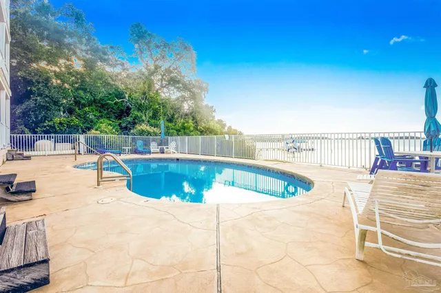 a view of a swimming pool with a lounge chair