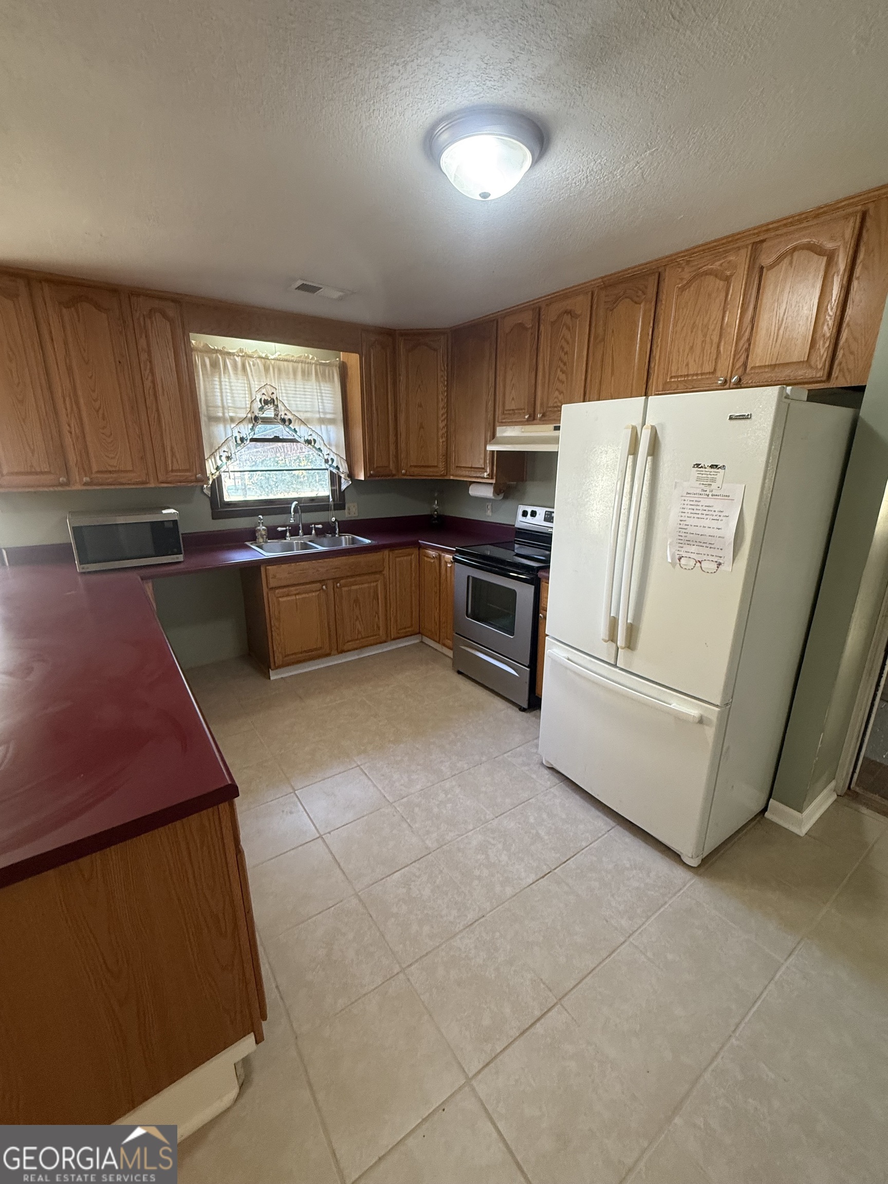 2068 Old Dalton Road Northeast Rome, GA 30165 - Photo 15 of 37 a kitchen with refrigerator and window