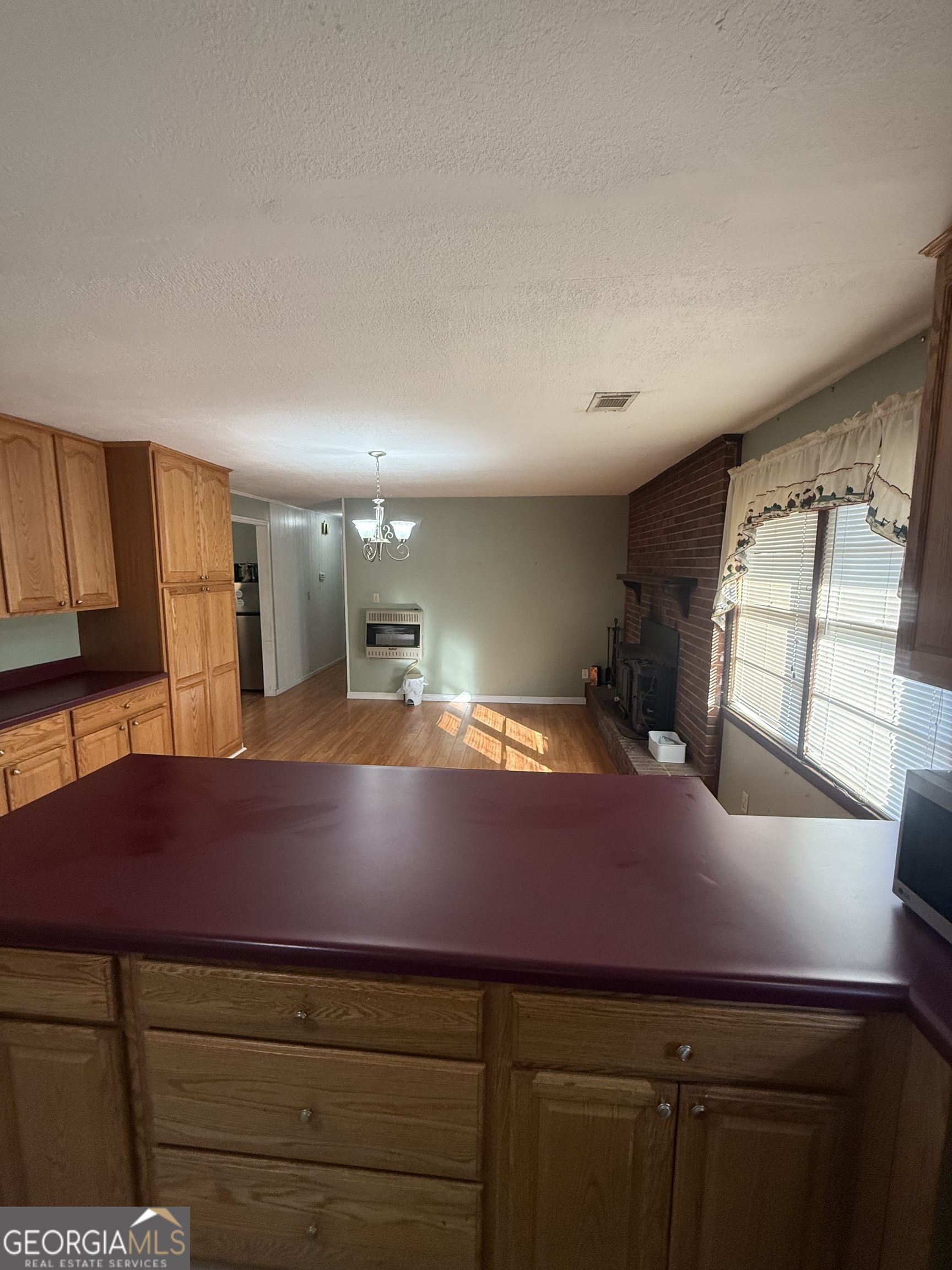 2068 Old Dalton Road Northeast Rome, GA 30165 - Photo 19 of 37 a open kitchen with cabinets and wooden floor