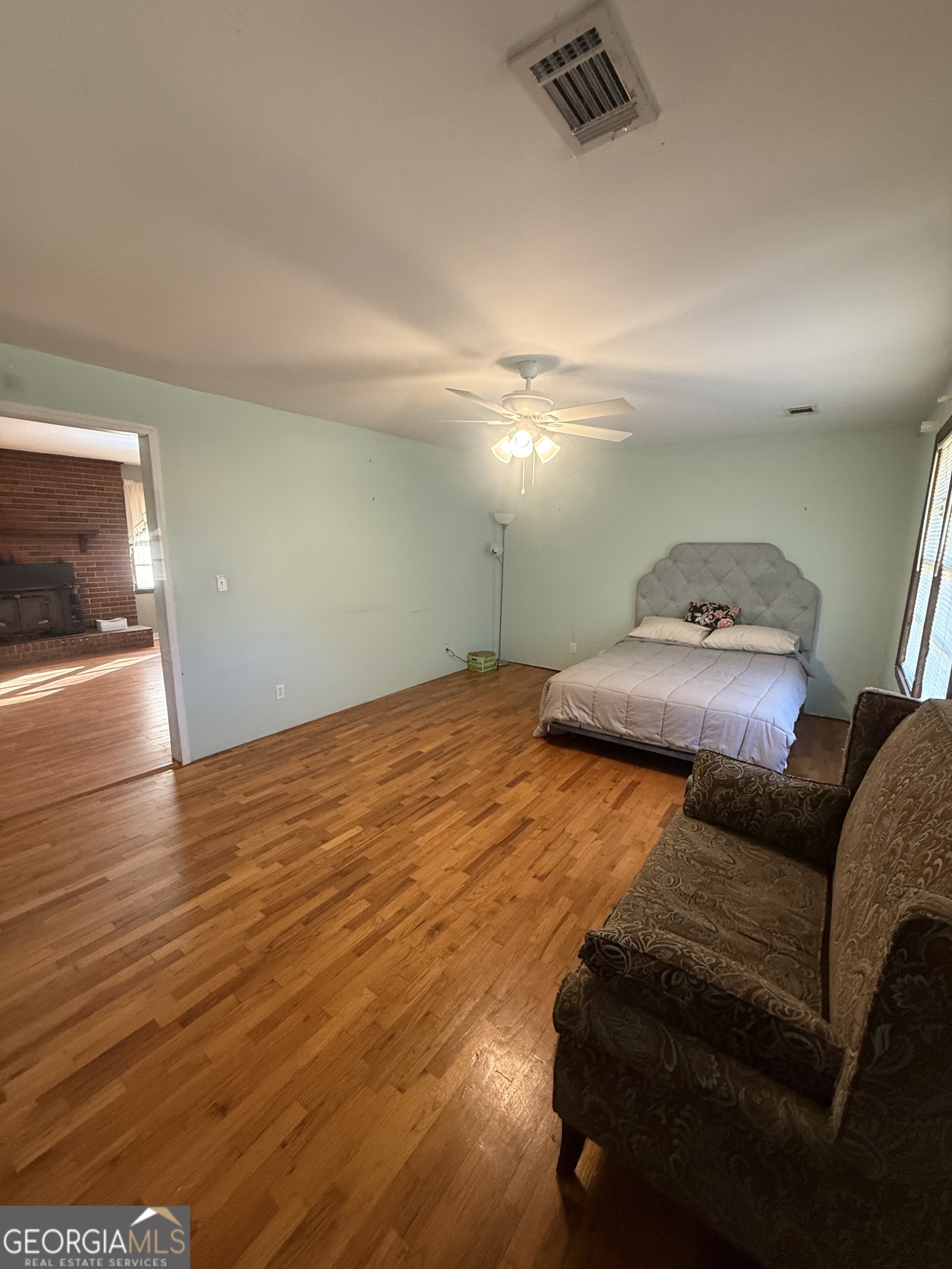 2068 Old Dalton Road Northeast Rome, GA 30165 - Photo 22 of 37 a bedroom with a bed and wooden floor