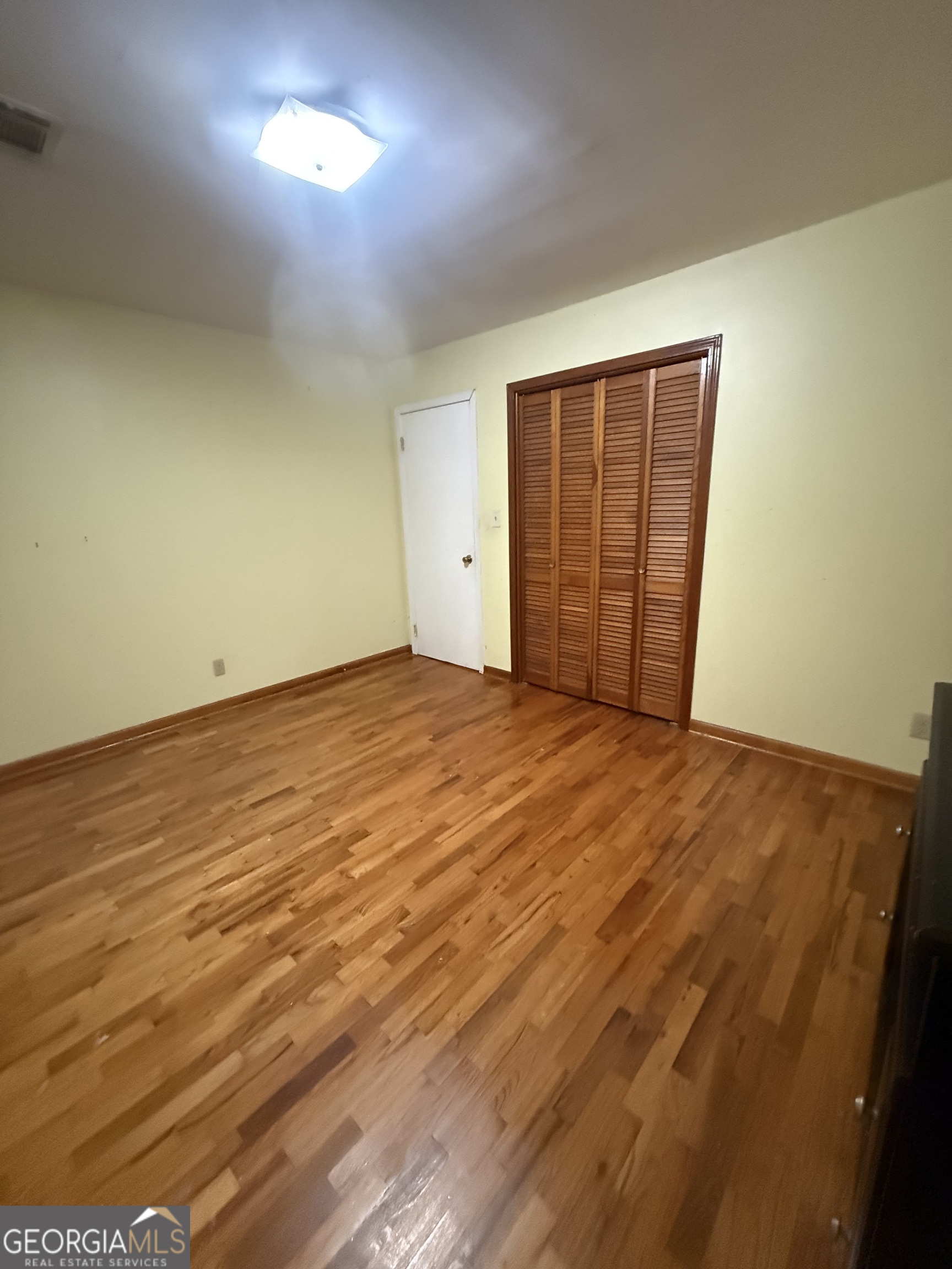 2068 Old Dalton Road Northeast Rome, GA 30165 - Photo 31 of 37 an empty room with wooden floor and windows