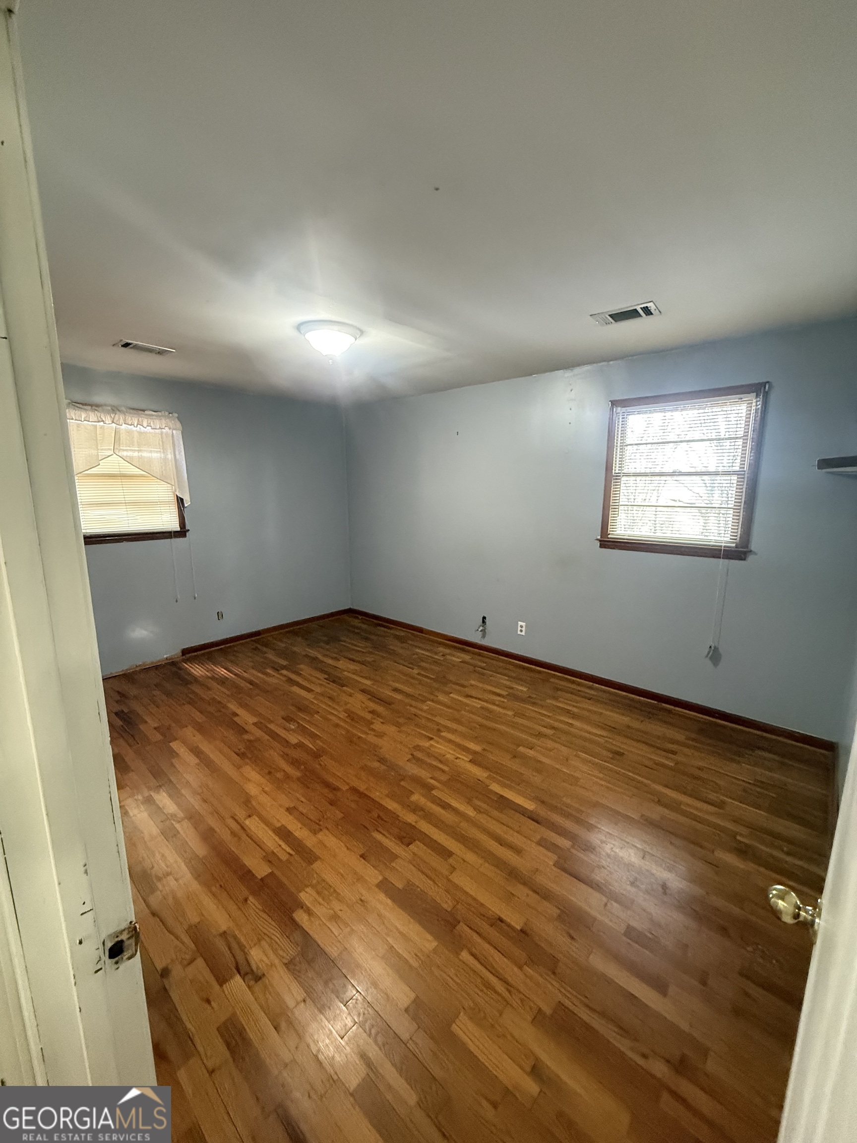 2068 Old Dalton Road Northeast Rome, GA 30165 - Photo 32 of 37 an empty room with wooden floor and windows