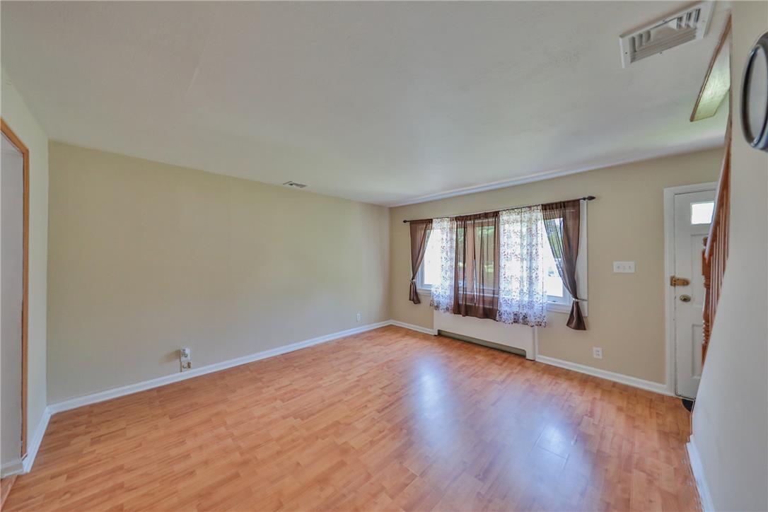 3050 Cornwall Road Bethlehem, PA 18017 - Photo 12 of 80 Natural light illuminates the warm hardwood flooring in this inviting living space.