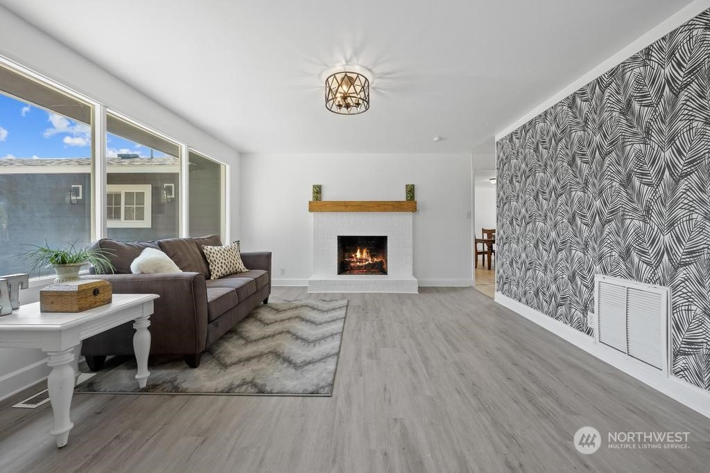 206 South Anderson Street Kennewick, WA 99336 - Photo 5 of 29 a living room with furniture and a fireplace