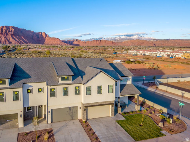 2600 Ocotillo Way, Unit 31 Santa Clara, UT 84765 - Photo 64 of 73 Contemporary townhome exterior featuring an attached garage, a covered entry, and a contrasting gray shingle roof