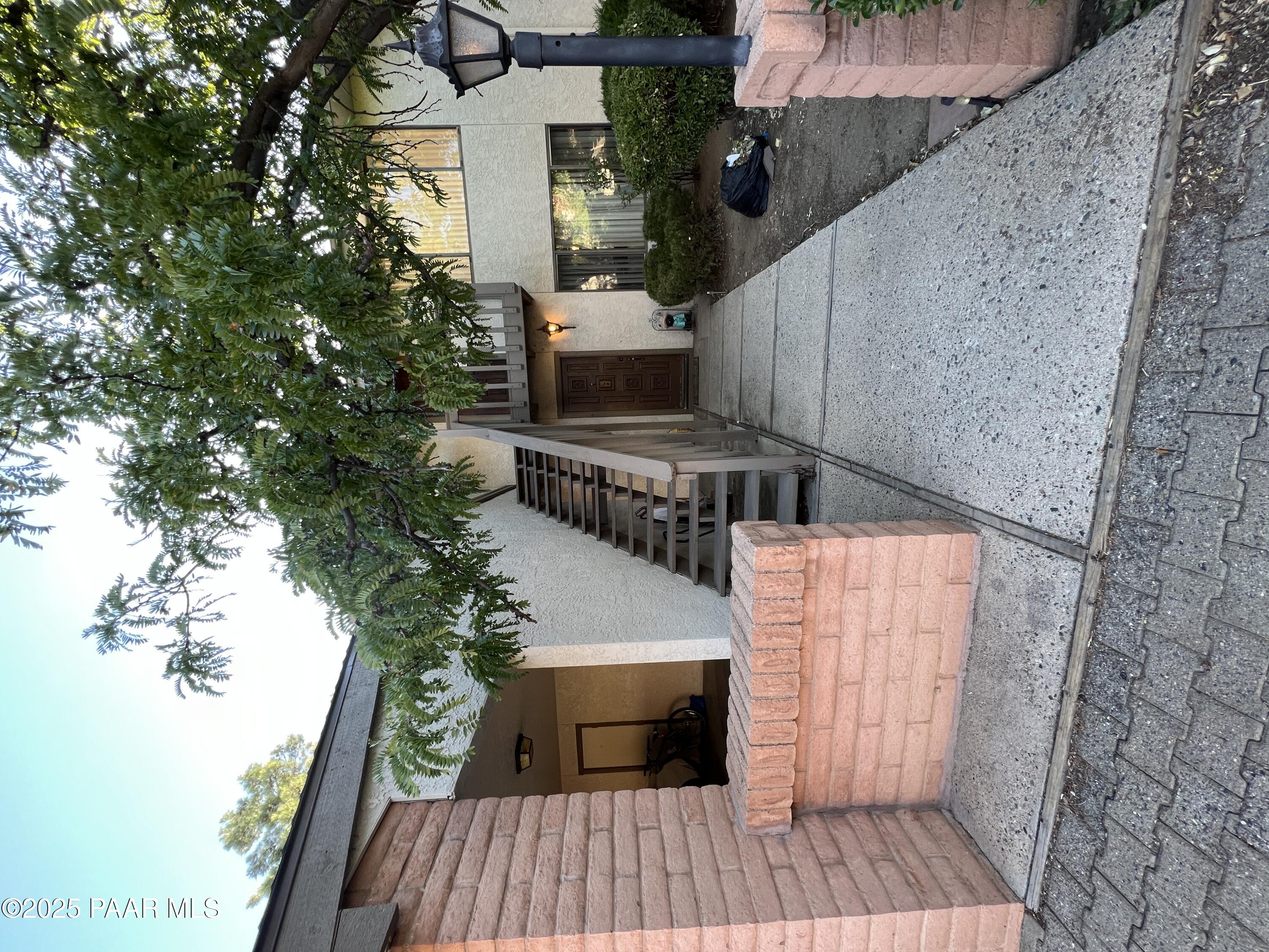 8860 East Yavapai Road, Unit C Prescott Valley, AZ 86314 - Photo 1 of 17 a view of a house with a yard