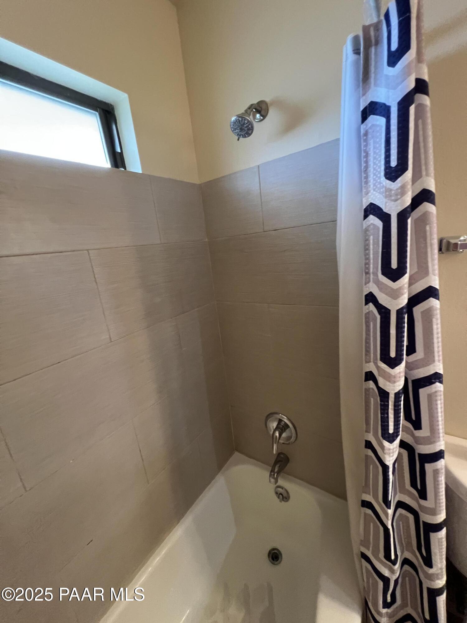 8860 East Yavapai Road, Unit C Prescott Valley, AZ 86314 - Photo 13 of 17 a bathroom with a bathtub and shower