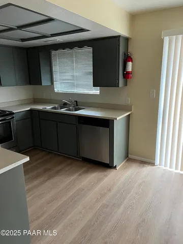 a kitchen with stainless steel appliances granite countertop a sink and a microwave