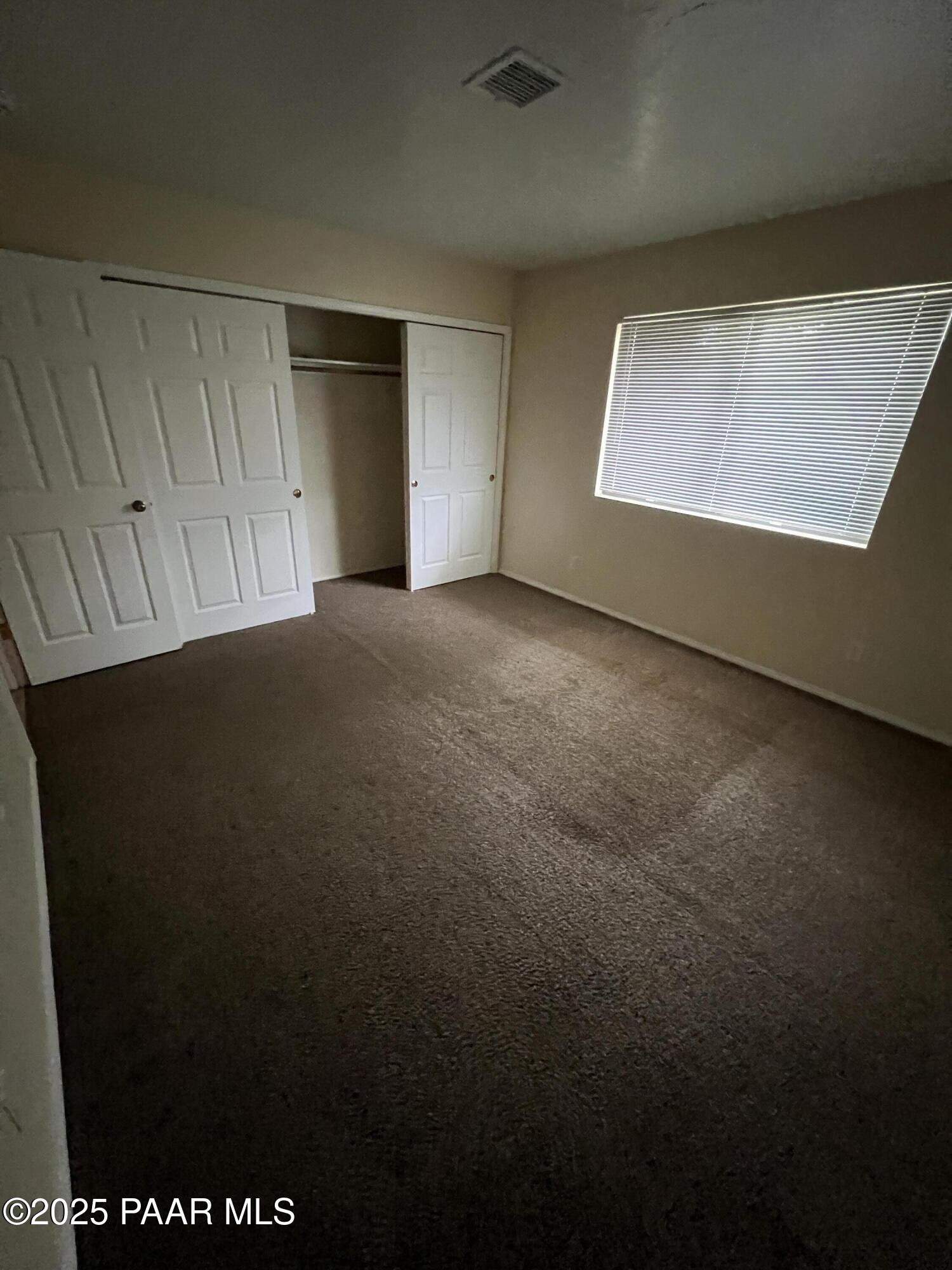 8860 East Yavapai Road, Unit C Prescott Valley, AZ 86314 - Photo 3 of 17 a view of an empty room with a window