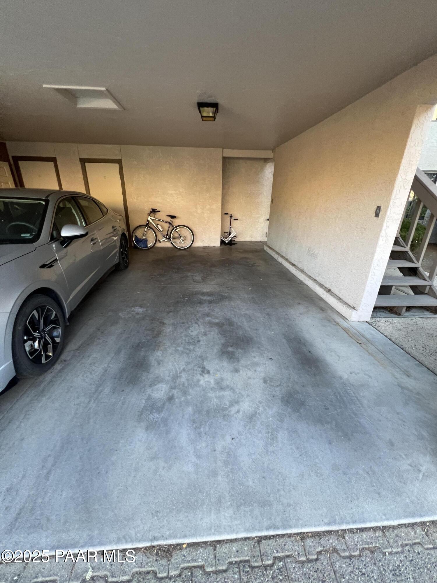 8860 East Yavapai Road, Unit C Prescott Valley, AZ 86314 - Photo 9 of 17 a view of parking garage with cars