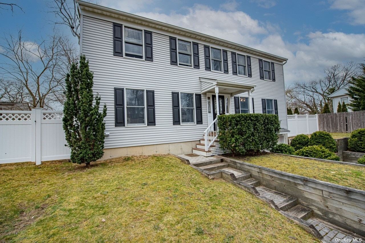 22 Jute Road Rocky Point, NY 11778 - Photo 1 of 1 a front view of a house with a yard