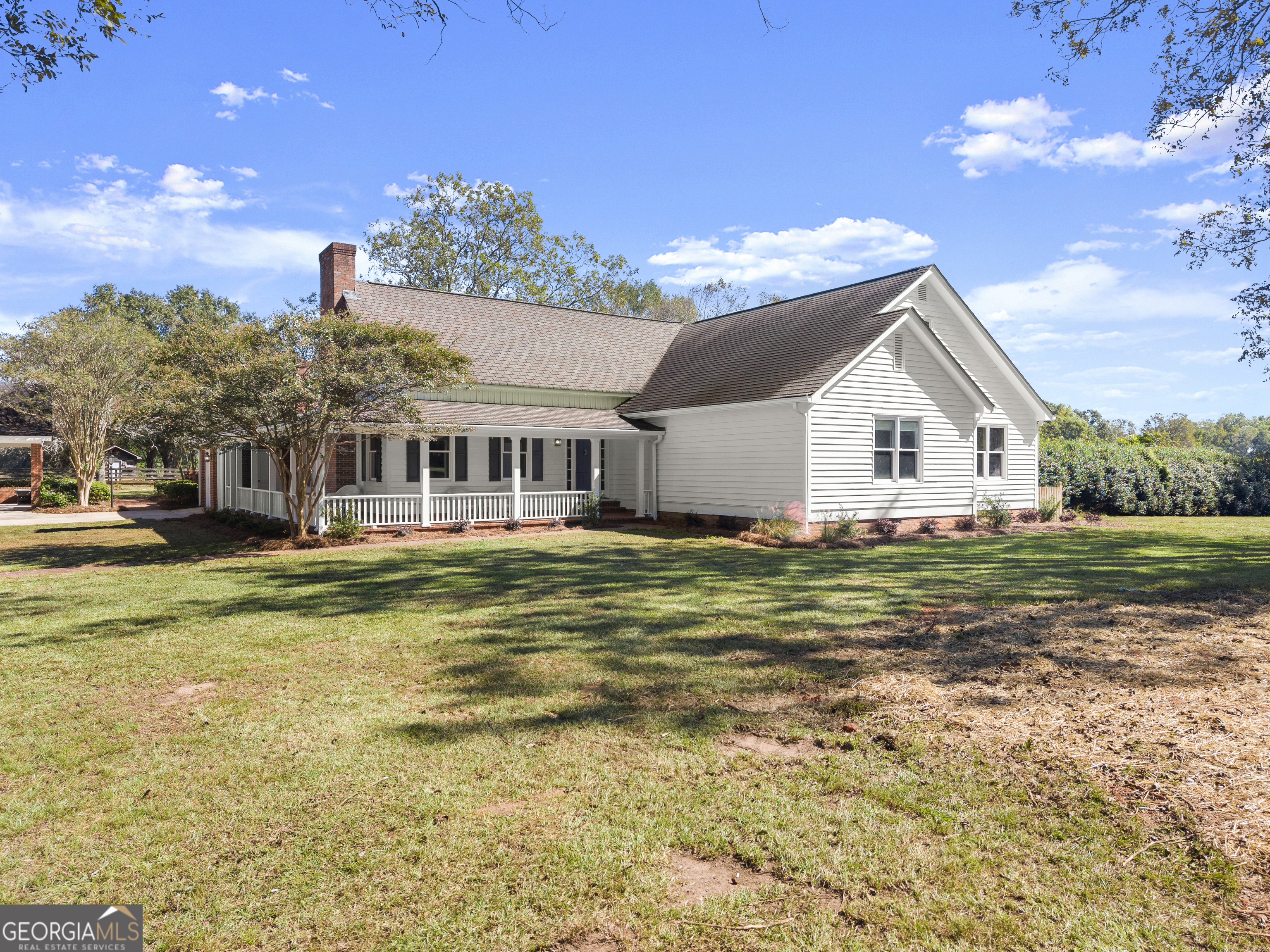 1972 Rest Haven Road Yatesville, GA 31097 - Photo 4 of 52 a view of a white house with a big yard and potted plants