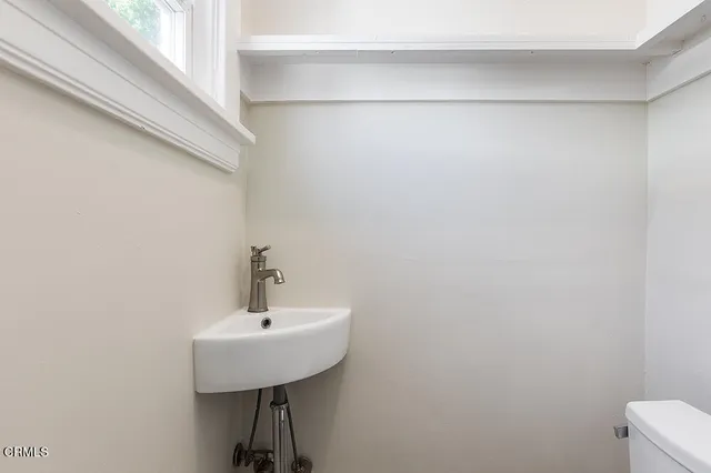 a bathroom with a sink a mirror and a toilet
