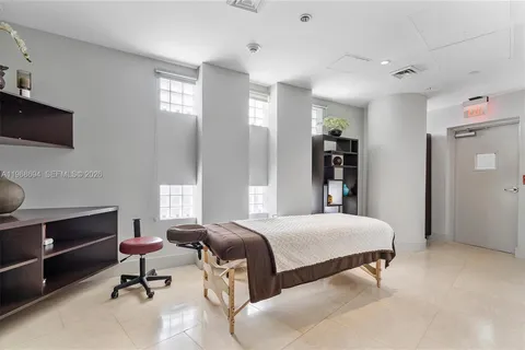 a bedroom with a bed and a bookshelf