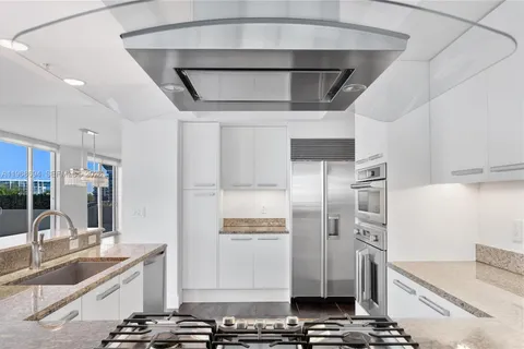 a kitchen with stainless steel appliances a refrigerator and a sink