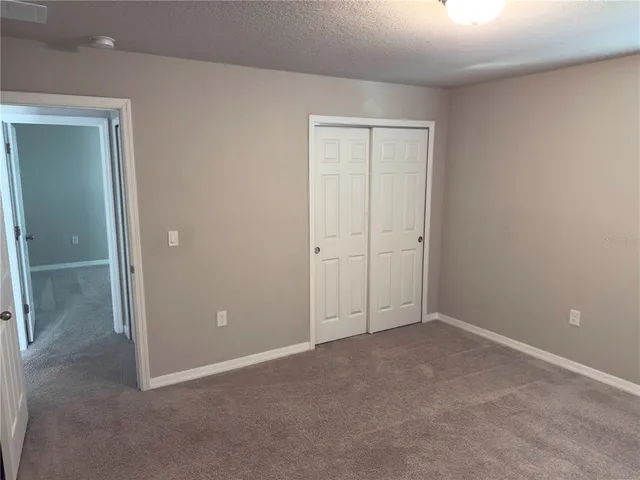 an empty room with closet area