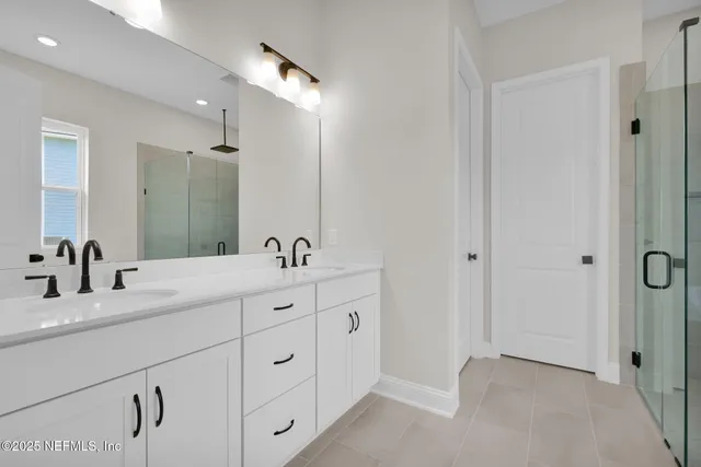 a bathroom with double sink and a mirror