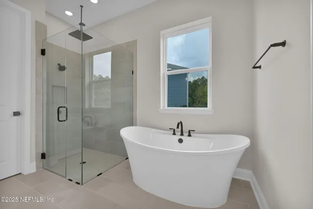 a white bath tub sitting next to a bathroom