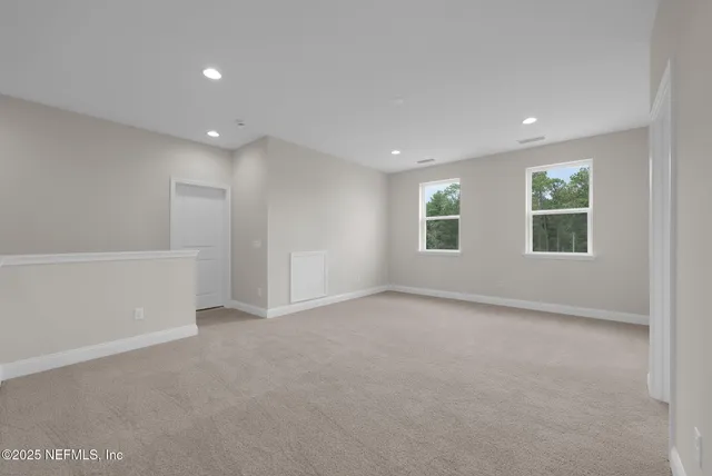 an empty room with windows and closet