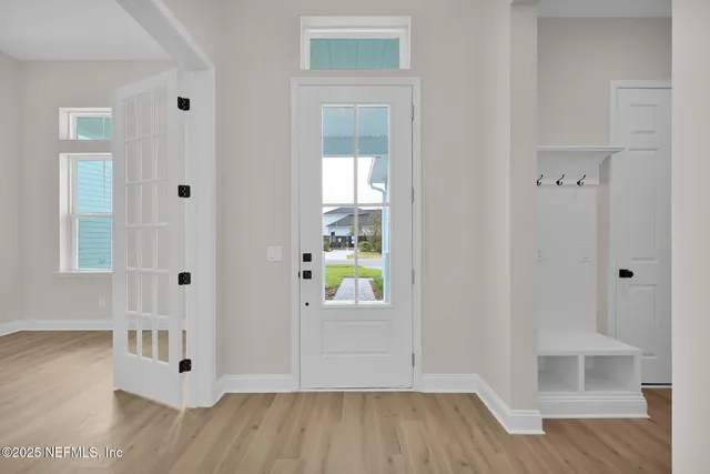 a view of an entryway with wooden floor
