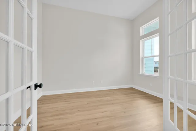 a view of a room with wooden floor and windows