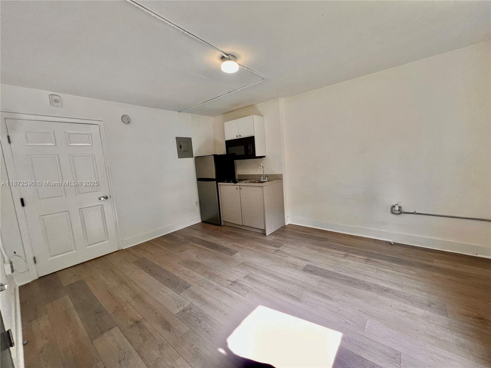 143 Southwest 9th Street, Unit 109 Miami, FL 33130 - Photo 1 of 5 a view of a kitchen with a sink and a stove top oven