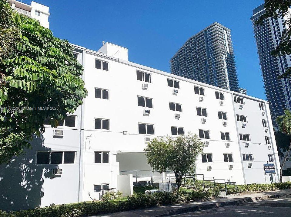 143 Southwest 9th Street, Unit 109 Miami, FL 33130 - Photo 2 of 5 a large building with a street