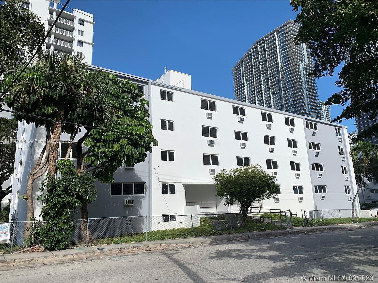 143 Southwest 9th Street, Unit 109 Miami, FL 33130 - Photo 3 of 5 a view of building with yard and staircase