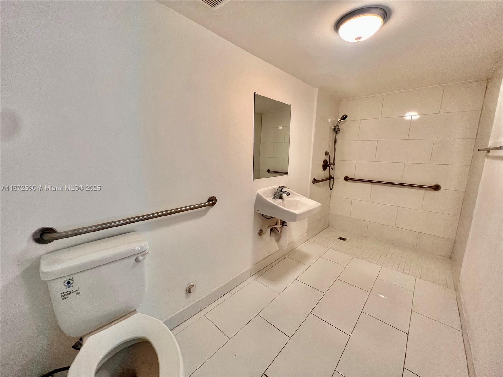 143 Southwest 9th Street, Unit 109 Miami, FL 33130 - Photo 5 of 5 a bathroom with a toilet and a shower