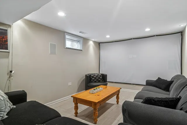 a living room with furniture and a lamp