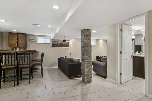 a dining room with furniture and kitchen view