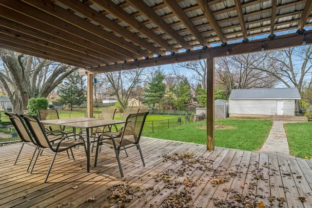 a view of a patio with a table chairs and a yard