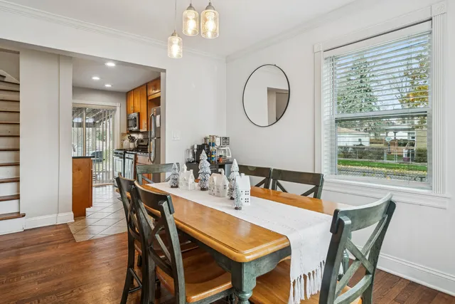 a dining room with furniture a window and wooden floor