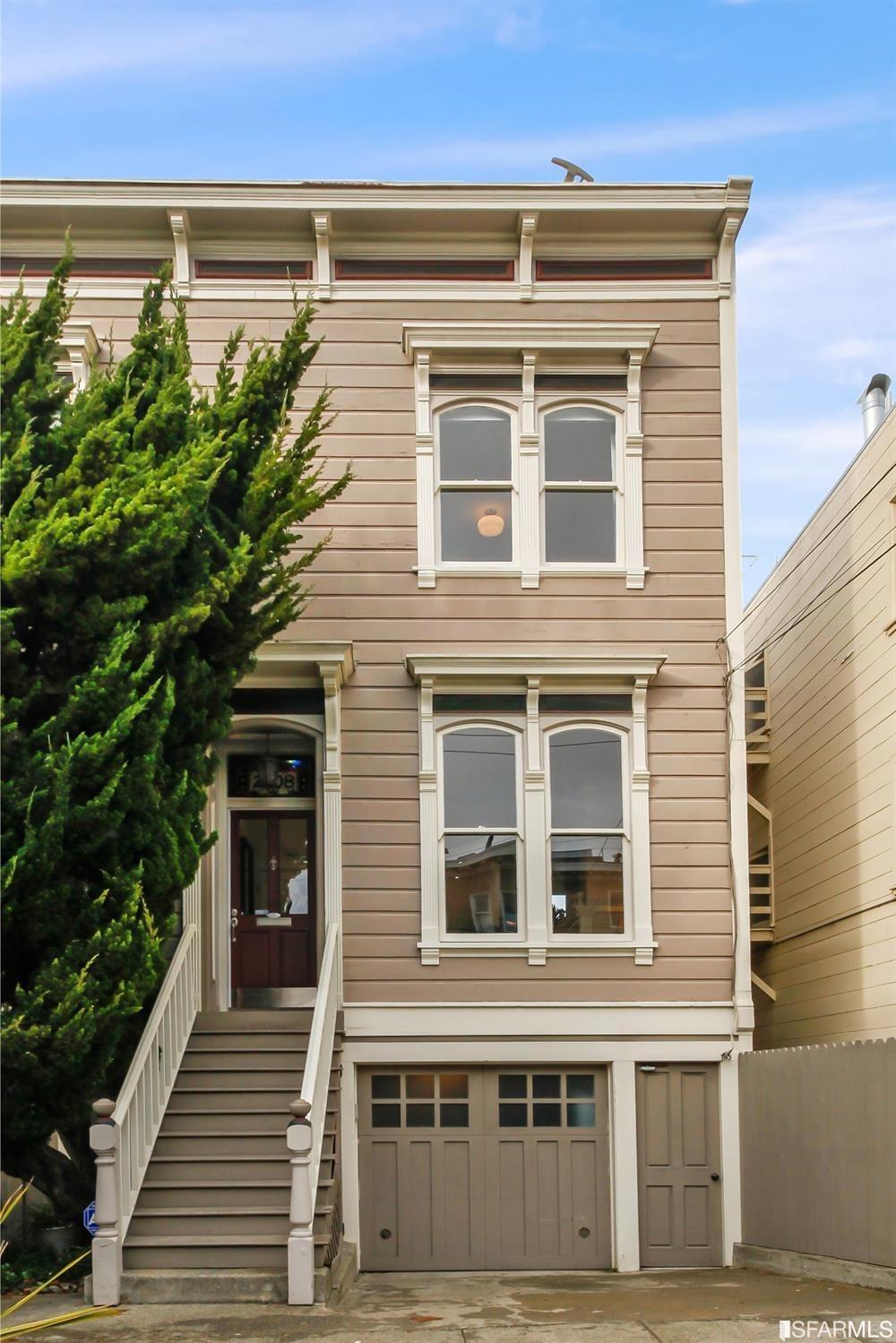 Semi-detached Victorian row house on a quiet, tree-lined Cow Hollow street.