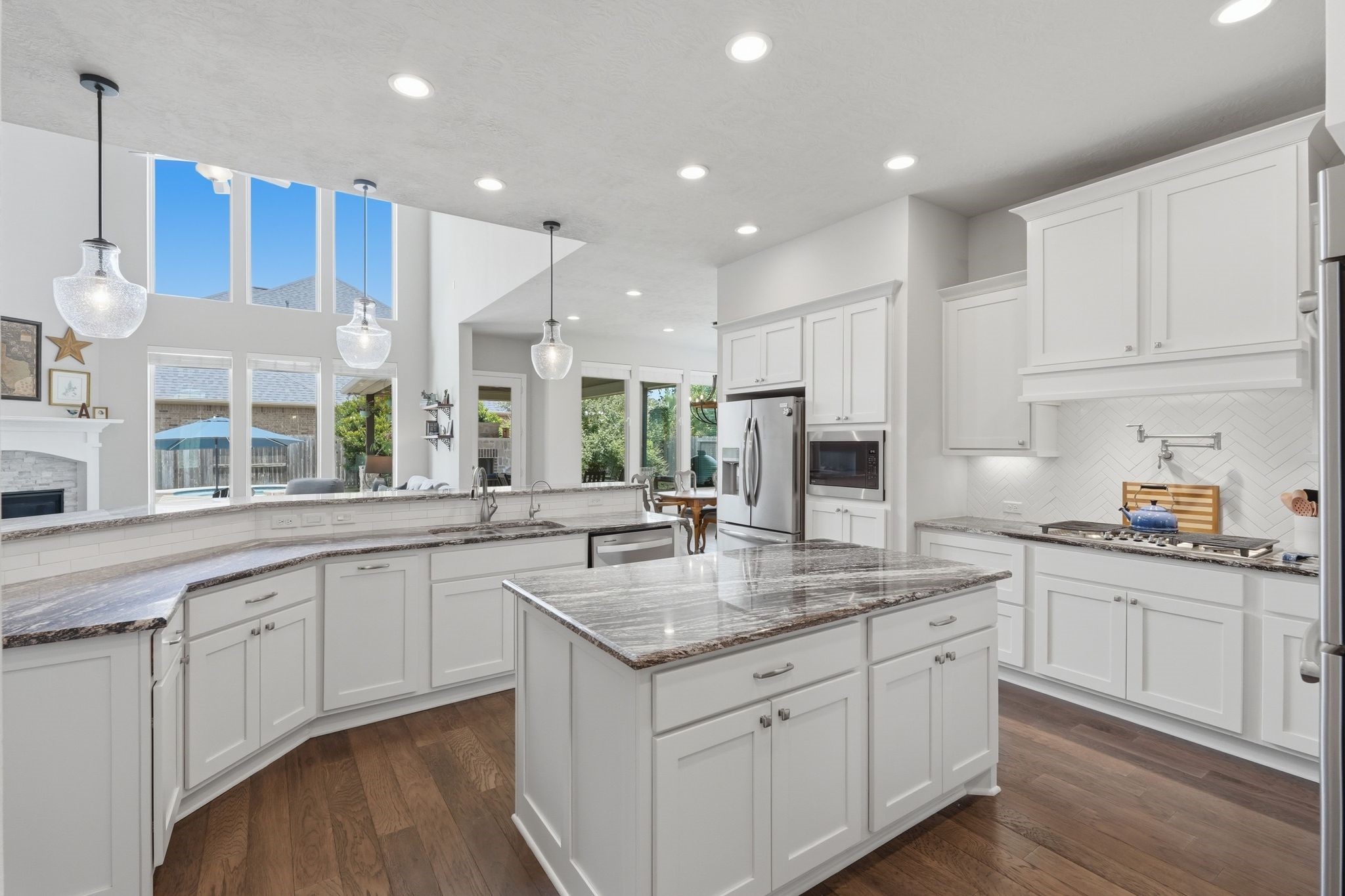 27705 South Slate Hills Lane Spring, TX 77386 - Photo 8 of 45 Kitchen boasting premium granite countertops, crisp white cabinetry, and updated lighting.