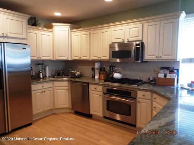 15 Main Avenue, Unit 2 Ocean Grove, NJ 07756 - Photo 3 of 15 a kitchen with stainless steel appliances granite countertop a stove a sink and a refrigerator