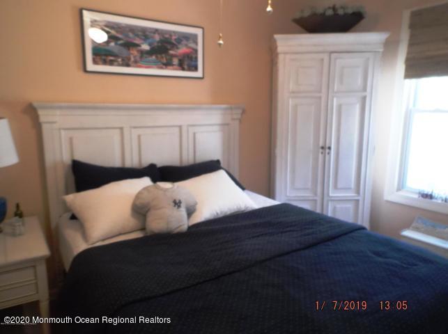 15 Main Avenue, Unit 2 Ocean Grove, NJ 07756 - Photo 4 of 15 a bedroom with a bed and a painting on the wall