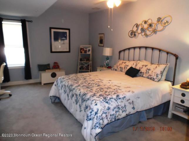 15 Main Avenue, Unit 2 Ocean Grove, NJ 07756 - Photo 7 of 15 a large bed sitting in a bedroom next to a window