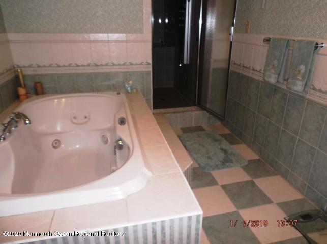15 Main Avenue, Unit 2 Ocean Grove, NJ 07756 - Photo 9 of 15 a bathroom with a bathtub and shower