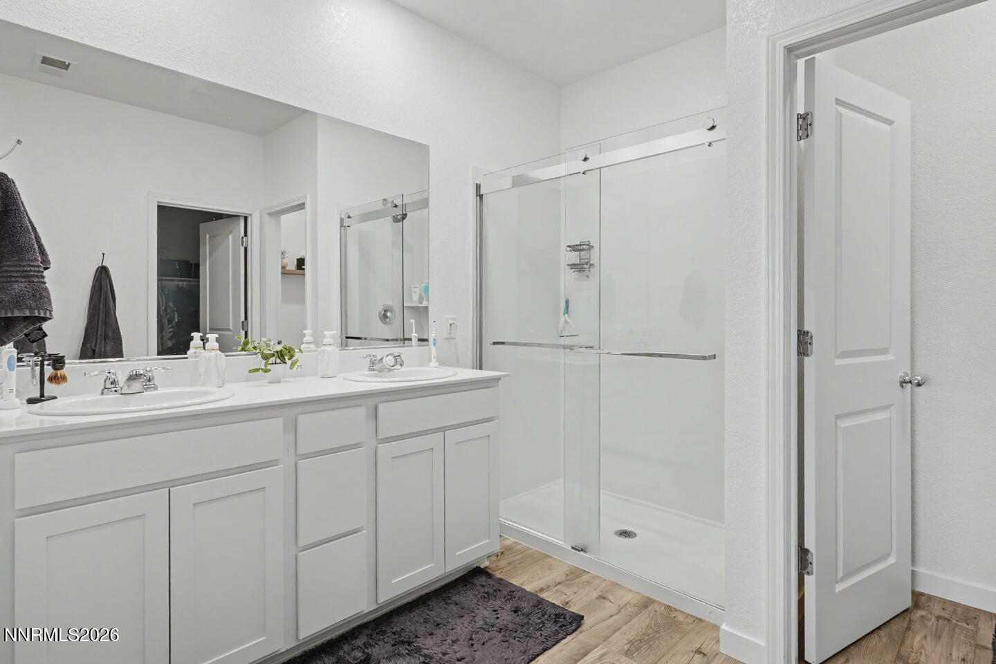 606 Sycamore Drive Fallon, NV 89406 - Photo 18 of 26 a bathroom with a double vanity sink and mirror