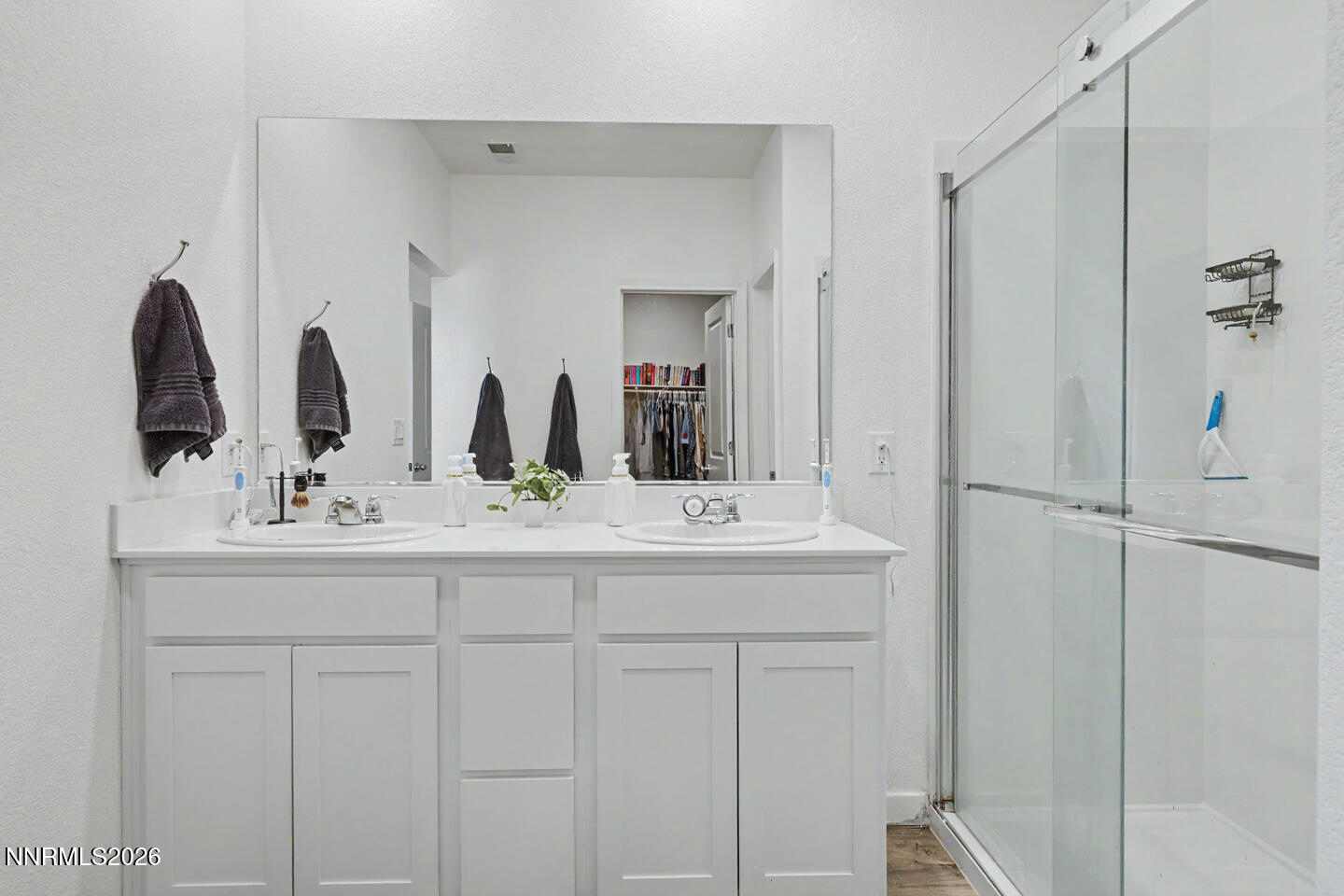 606 Sycamore Drive Fallon, NV 89406 - Photo 19 of 26 a bathroom with a double vanity sink and a mirror