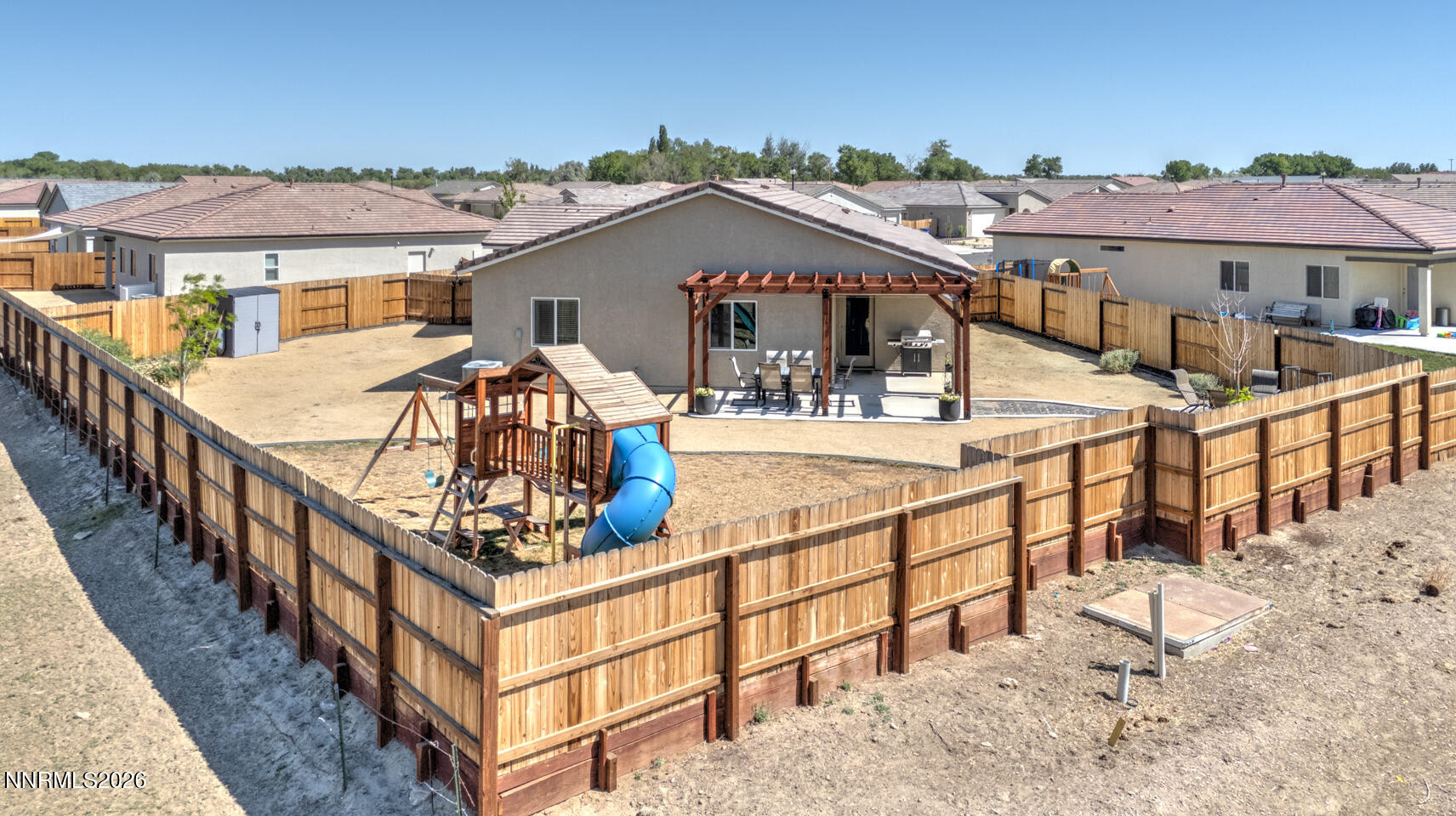 606 Sycamore Drive Fallon, NV 89406 - Photo 22 of 26 a view of a house with wooden deck and furniture