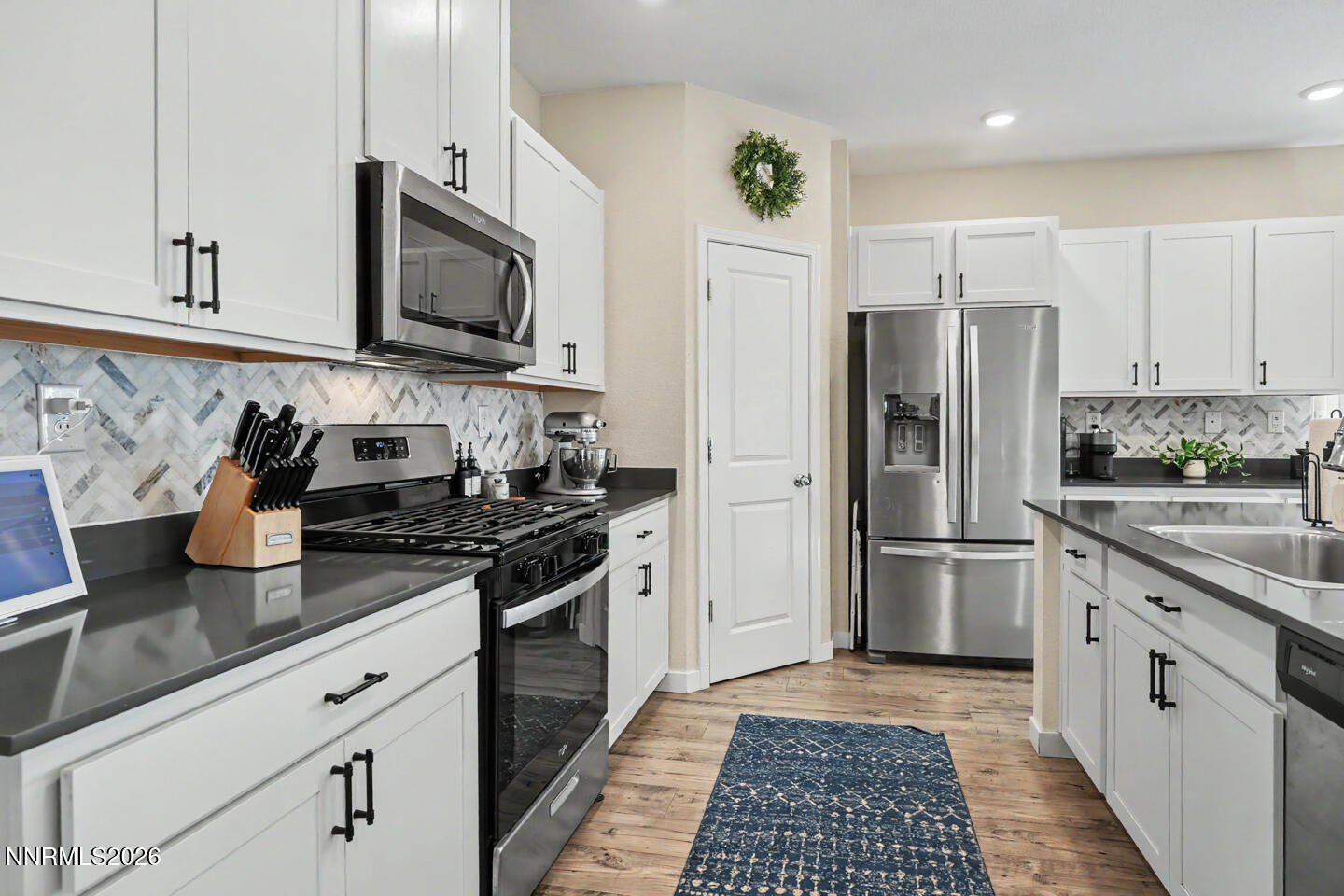 606 Sycamore Drive Fallon, NV 89406 - Photo 6 of 26 a kitchen with stainless steel appliances granite countertop a refrigerator sink and stove