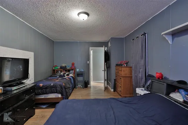 a bedroom with furniture and a flat screen tv