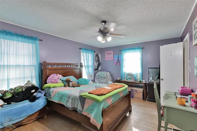 a bedroom with a bed dresser and a window